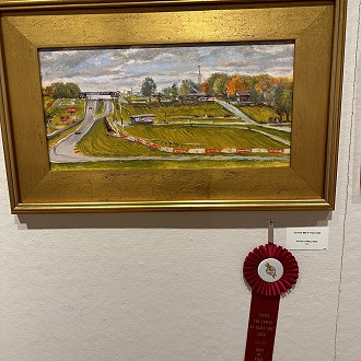 Best of Road America Award: “Catch Me if you Can” by Dan Rizzi. This panoramic view of Road America caught my eye. This is a very complicated composition that took in lots of detail. But it holds together nicely with the color choices and brush strokes. I enjoy the pop of red here and there to help balance the greens. Well Done!