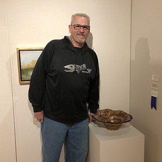 Merit Award to Dick Bemis for “Bad Storm Brewing” Wood Turned White Oak Burl. Judge Patrick’s Comment: With woodturning, I have been told that you risk danger and the unknown in the search for the beauty that may emerge. This piece, a shining example of a risk well taken.
