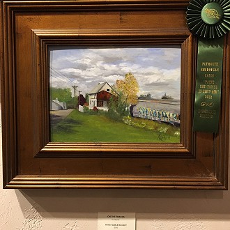 Honarable Mention- Judges Notes: “On the Tracks” by Adele Reichert is an interesting intersection of new and old, urban and rural. The telephone wires and the train pull your eye into to the focal point of the house, which seems to be run down. The piece seems to be about changing times in our small towns. It is recognizable, everyday, not elevated, but worth documenting. Nicely done.