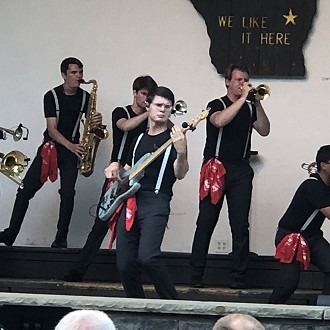 Noah playing the electric guitar in the 2021 performance at the Plymouth City Park.