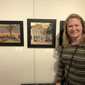 3rd Place Award: Naomi Tiry Salgado, HARTMAN’S BAKERY. This painting inspired me to leave the Arts Center and find the original location because the color of this painting looked (to me eye) to be the color a homemade “sugar-cookies” or a loaf of freshly baked bread with a golden crust, I had to see for myself what this bakery looks like. The artist actually made the building MORE DELICIOUS than it might appear upon first view and, therein, captured the ESSENSE and FEELING of the space in the most poetic and emotional way (exactly what a traditional plein-air painting seeks to do; it expresses a belief in the goodness of humanity and appeals to the senses). For anyone who has ever been to this bakery, this painting will inspire you to bring home a box of cookies from this very bakery.